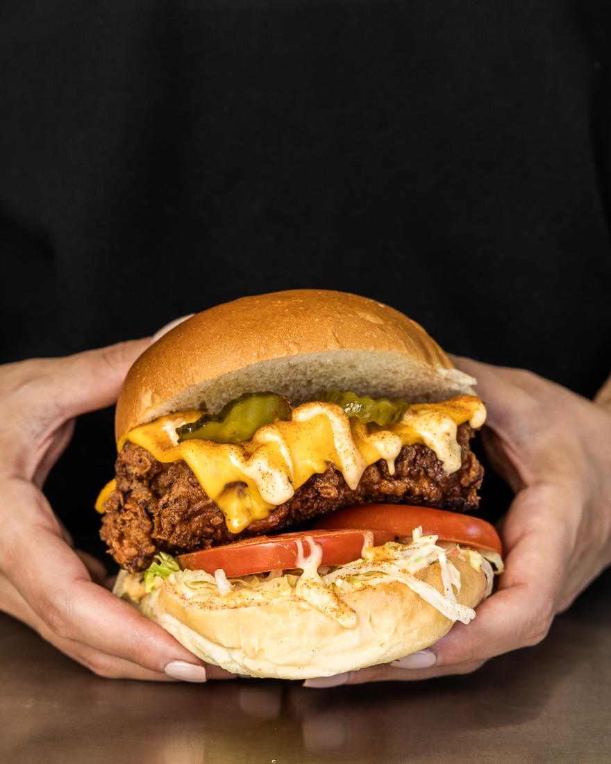 Cheeky Burger held in two hands